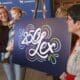 People unveiling a 250 Lex graphic design