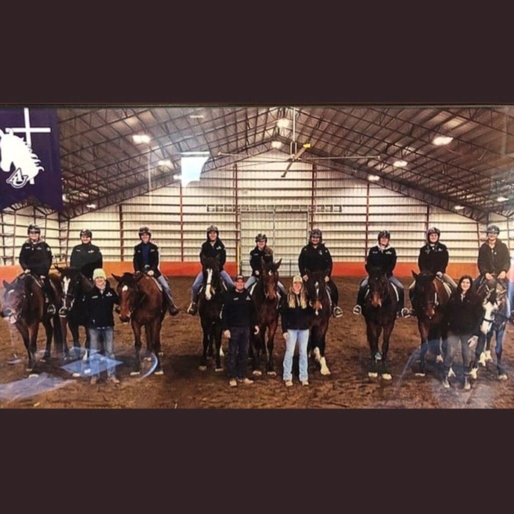 Students on horses in a riding arena