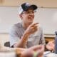 Student smiling and talking in a classroom