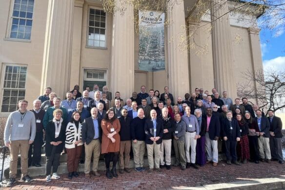 Group of people standing in front of a building with large columns