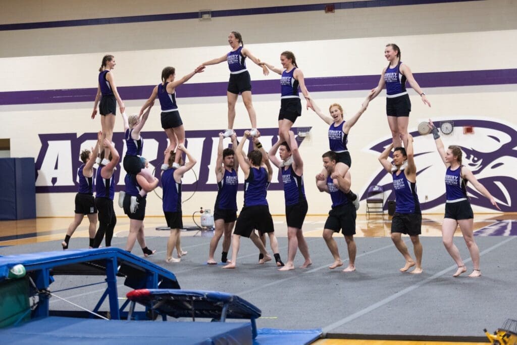 Tumbling team doing a gymnastics stunt