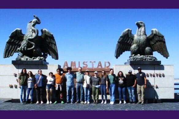 Group of students standing by the Amistad monument