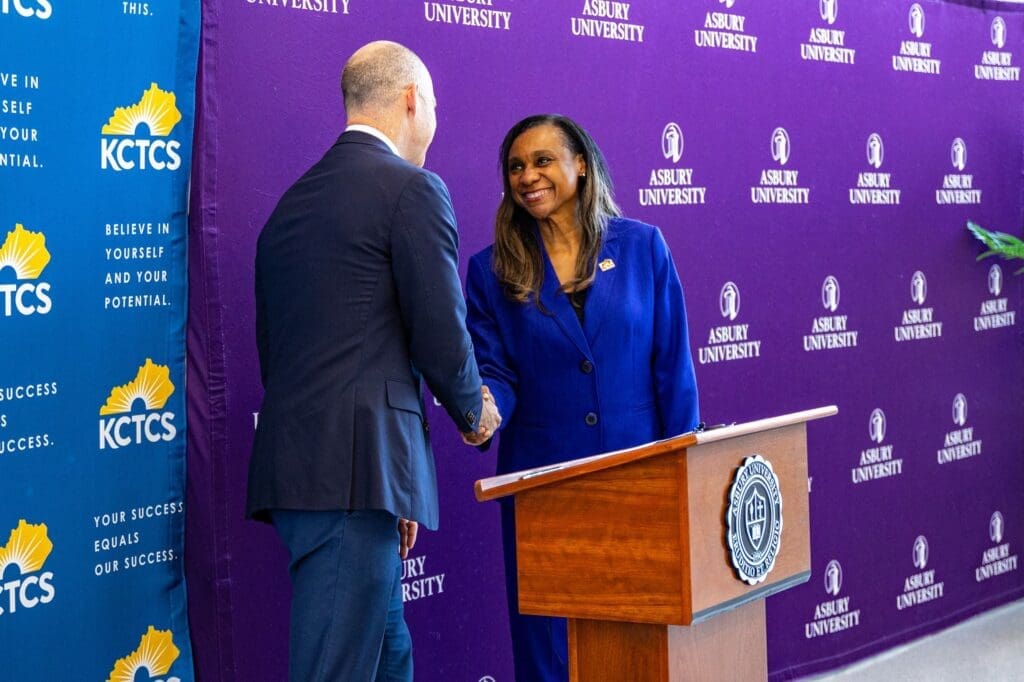 Dr. Kevin Brown and Dr. Reneau Waggoner shaking hands