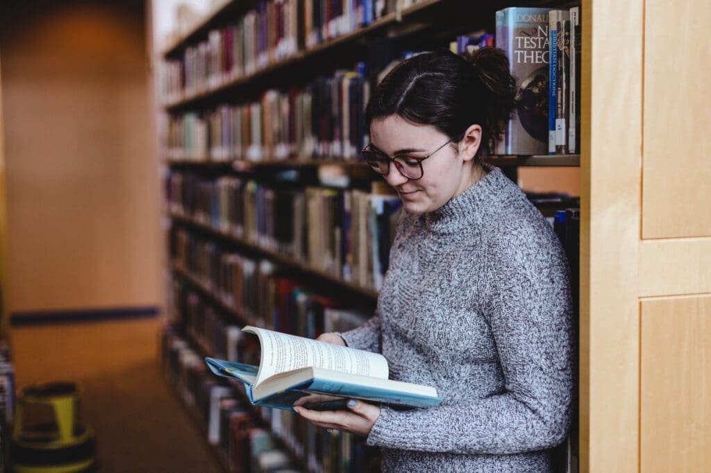 person reading books in a library