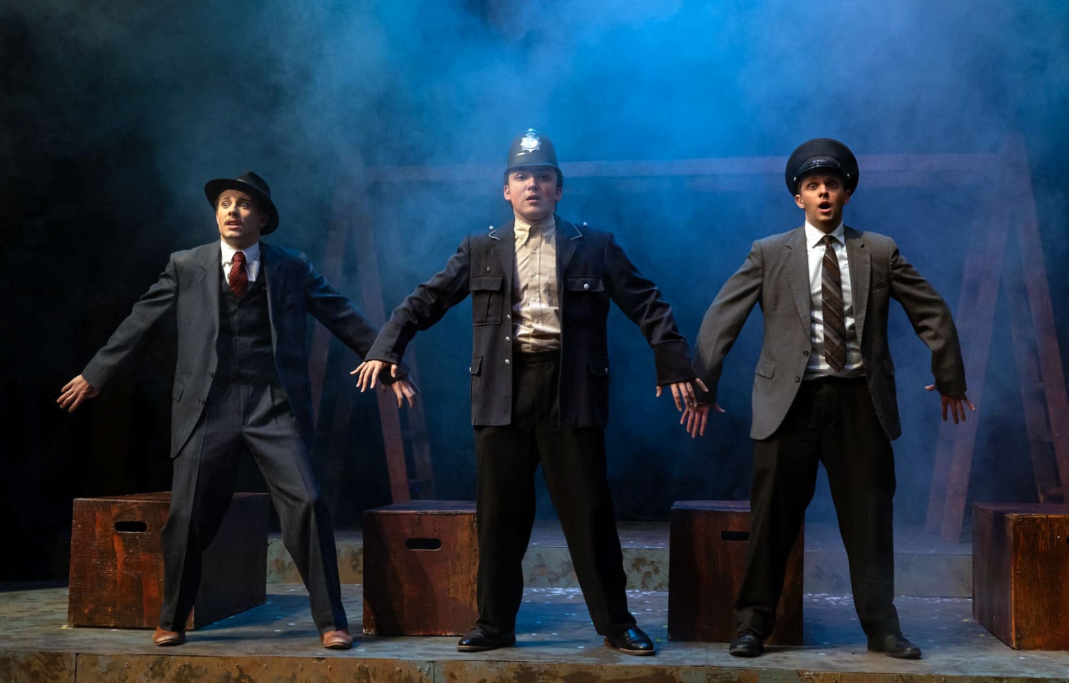 Asbury University's theater production Three in a Row three males in a row on the stage.