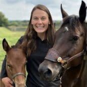 Headshot of Lizzie Guthrie with two horses