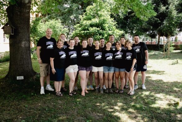 Group of people standing under a tree