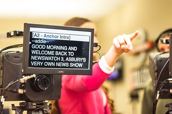 teleprompter and student pointing in news studio