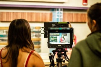 Student on camera in news studio