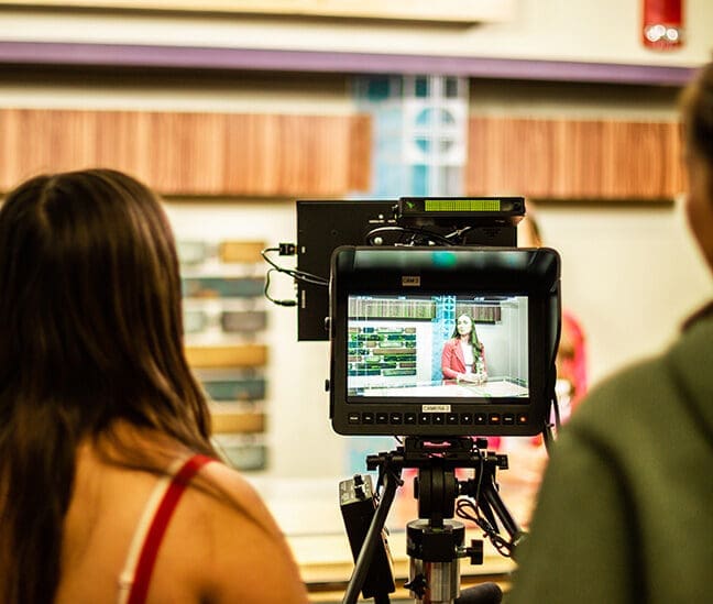 Student on camera in news studio