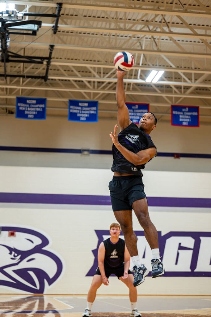 Male basketball student leaps for the hoop