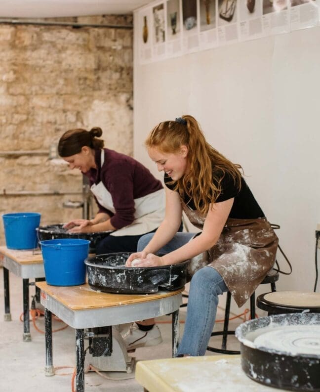 Asbury art students work at ceramic stations in the art annex