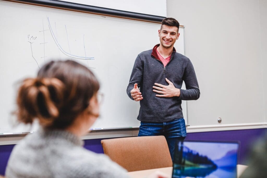 Asbury University student presenting to another student.
