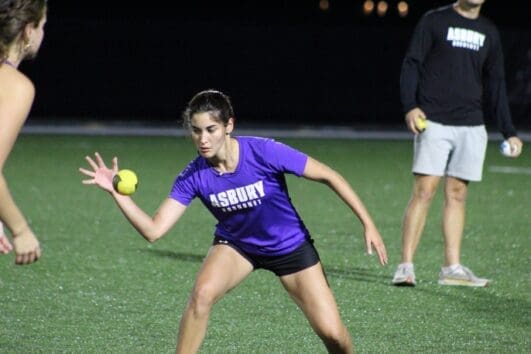 Asbury female student catches the ball in club sports