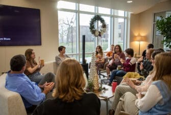 Asbury students sitting with English professors drinking tea