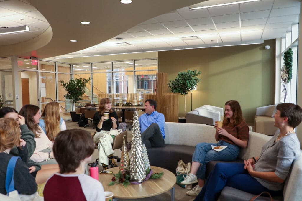 Asbury students sitting with English professors drinking tea