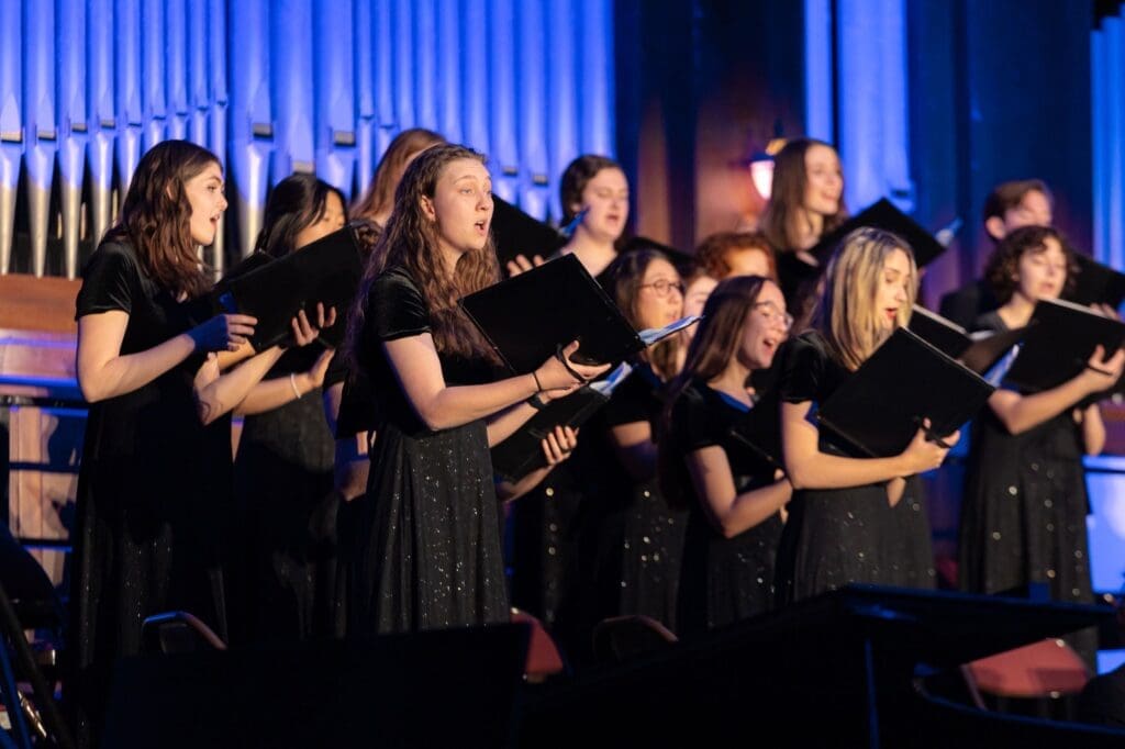 Female vocalists performing in the Asbury Chorale during a concert.