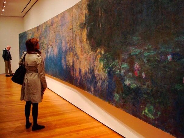 Asbury Art student looking at a large Monet painting in the Paris Museum of Modern Art.