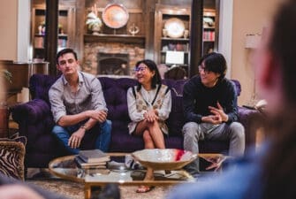 Three Asbury psychology honors students sit together on a couch in a casual setting