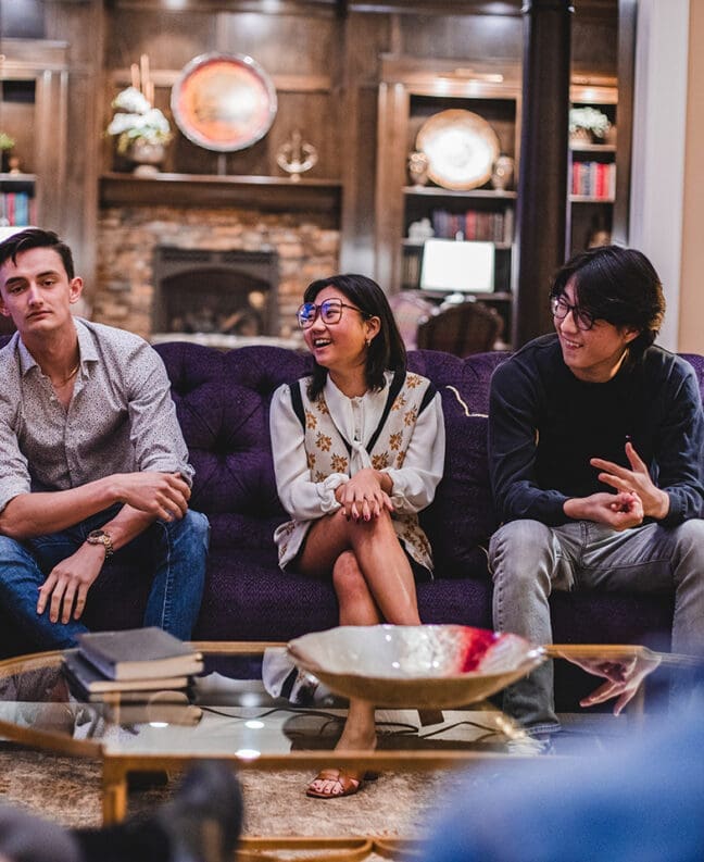 Three Asbury psychology honors students sit together on a couch in a casual setting