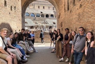 Asbury students sit inside the Colosseum in Rome, italy