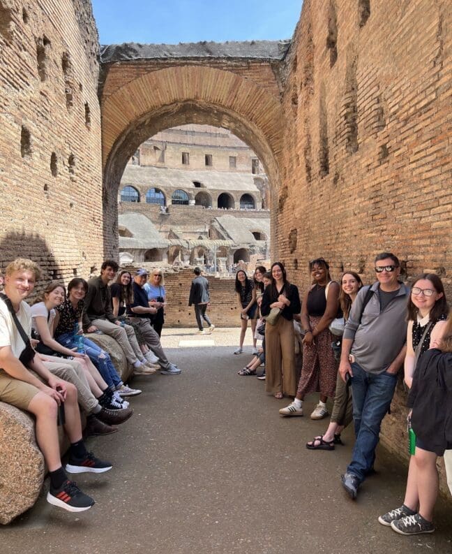 Asbury students sit inside the Colosseum in Rome, italy