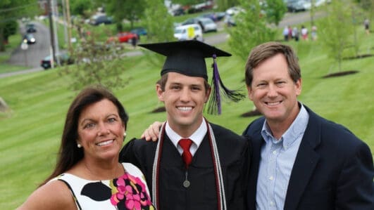 Joy Griffin, Asbury parent, smiles at graduation with her son and husband