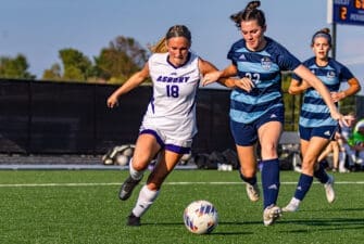 AU women's soccer player runs after the ball on the field