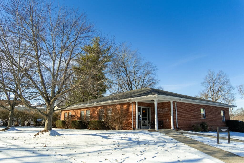 Front entrance of the Center for Wholeness & Wellness at Asbury University, the campus clinic, shown in winter with snow on the ground.