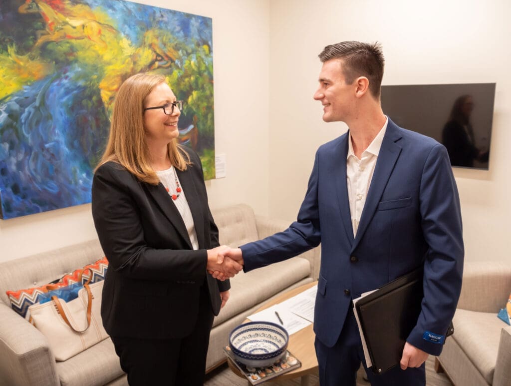 A professional employer shaking hands with a student to represent internship opportunities with Asbury University.