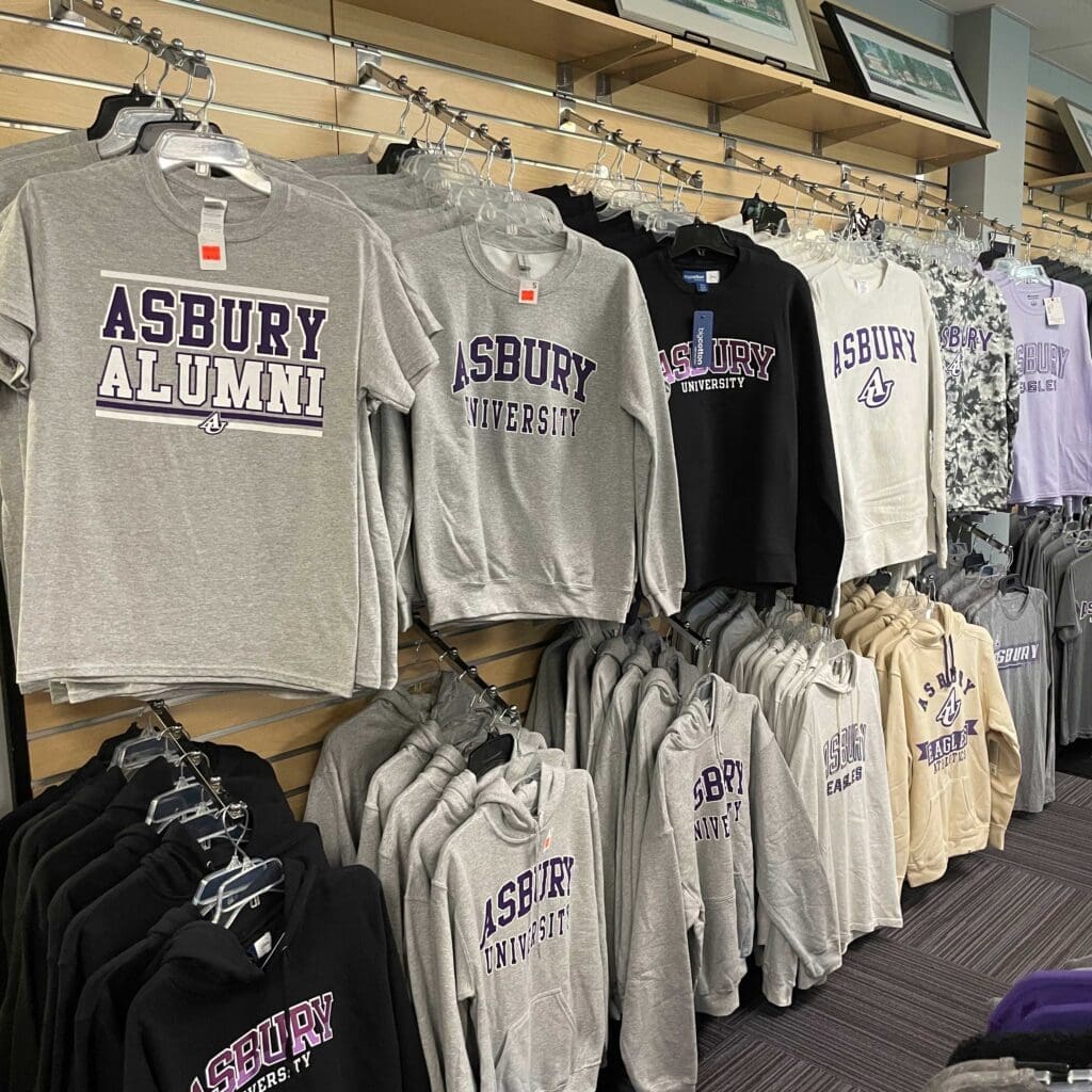 Asbury University Eagle Outlet rows of the interior of store with tee shirts.