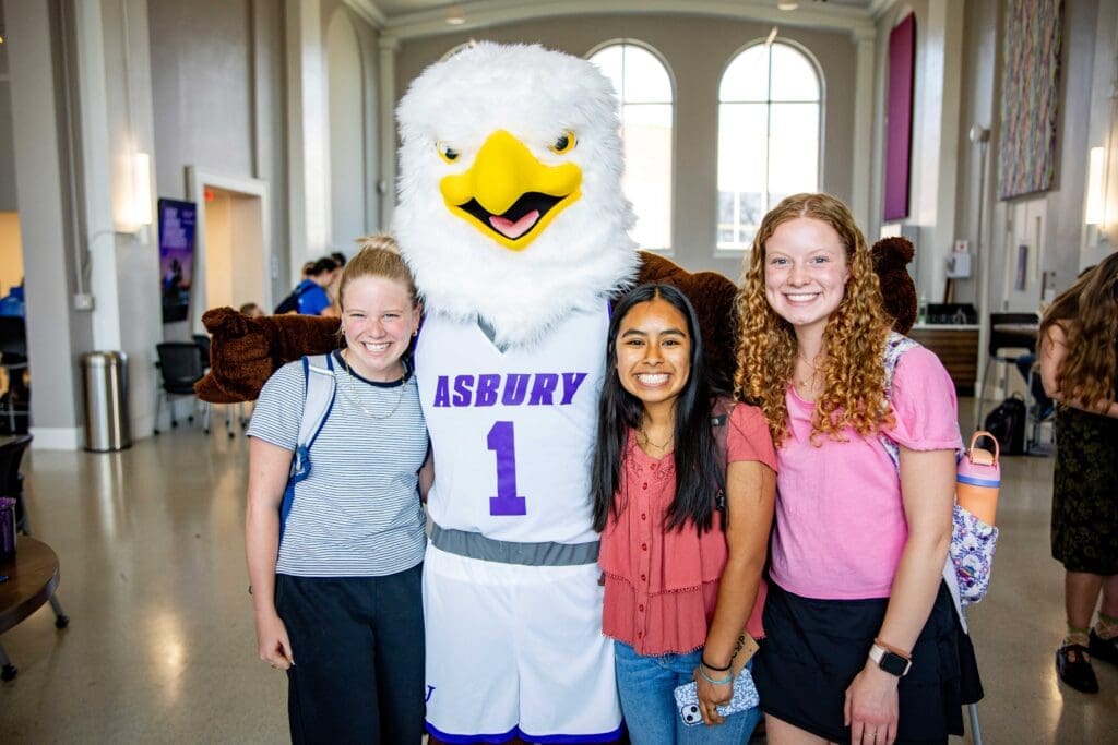 Group of students with Isaiah the Asbury eagle mascot.