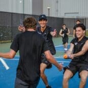 Asbury Men's Tennis Team players celebrate victory.
