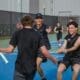 Asbury Men's Tennis Team players celebrate victory.