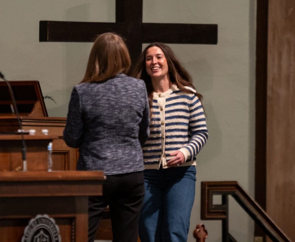 asbury student athlete accepts award on stage
