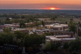 an aerial view of asbury university's campus trees at sunset