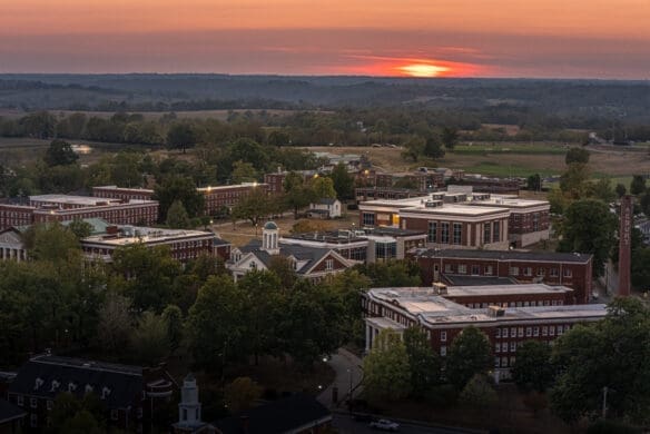 an aerial view of asbury university's campus trees at sunset