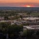 an aerial view of asbury university's campus trees at sunset