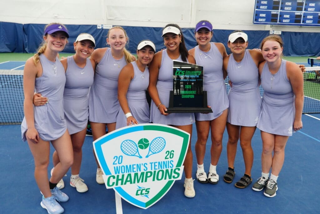asbury women's team stand smiling
