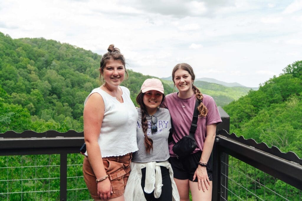 Asbury's Launching Well for Asbury Alumni group on an overlook of blue sky, green knobs.