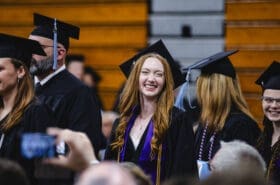 An Asbury University athlete smiles at Commencement