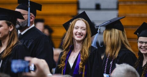 An Asbury University athlete smiles at Commencement